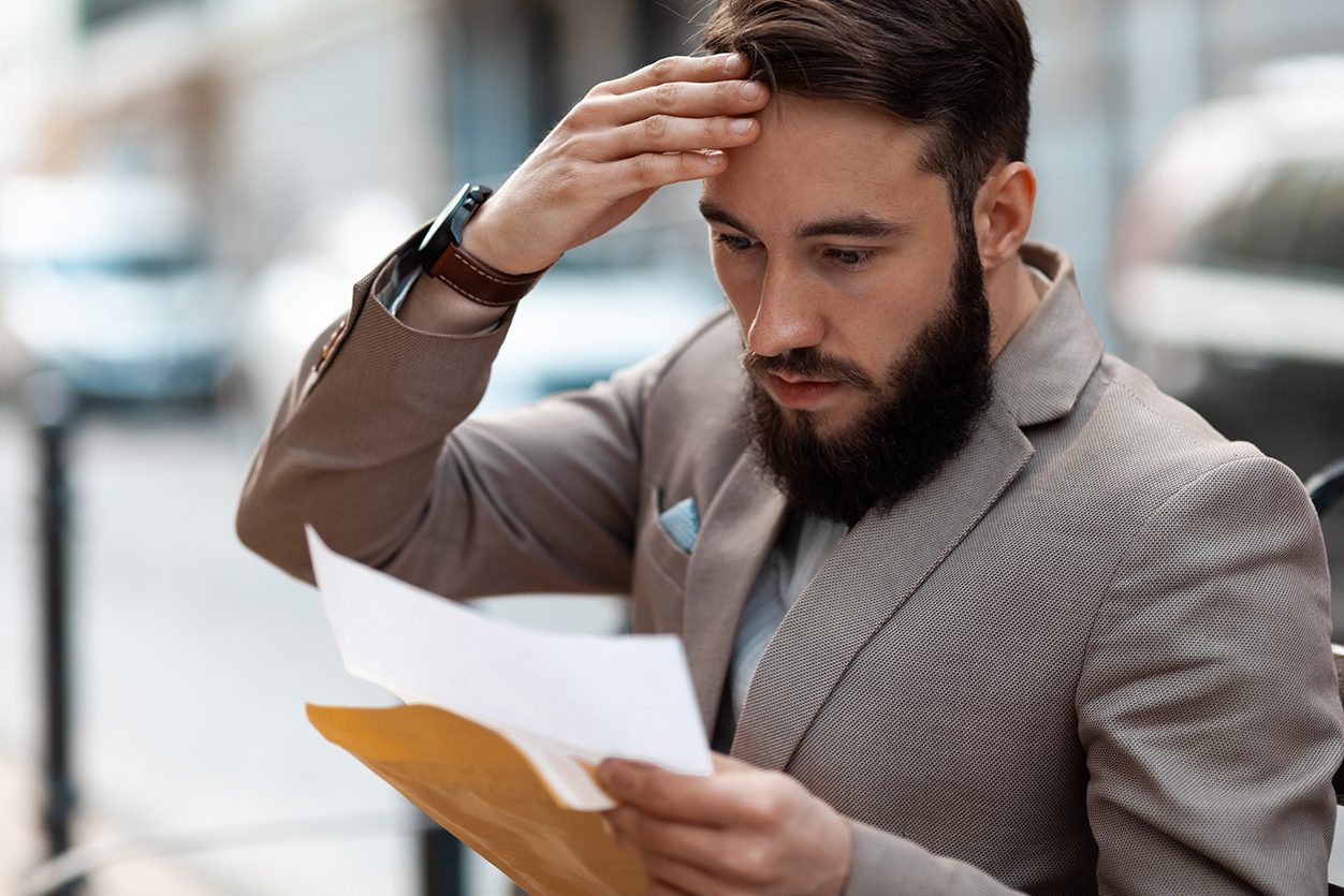 Man looking worried at a document