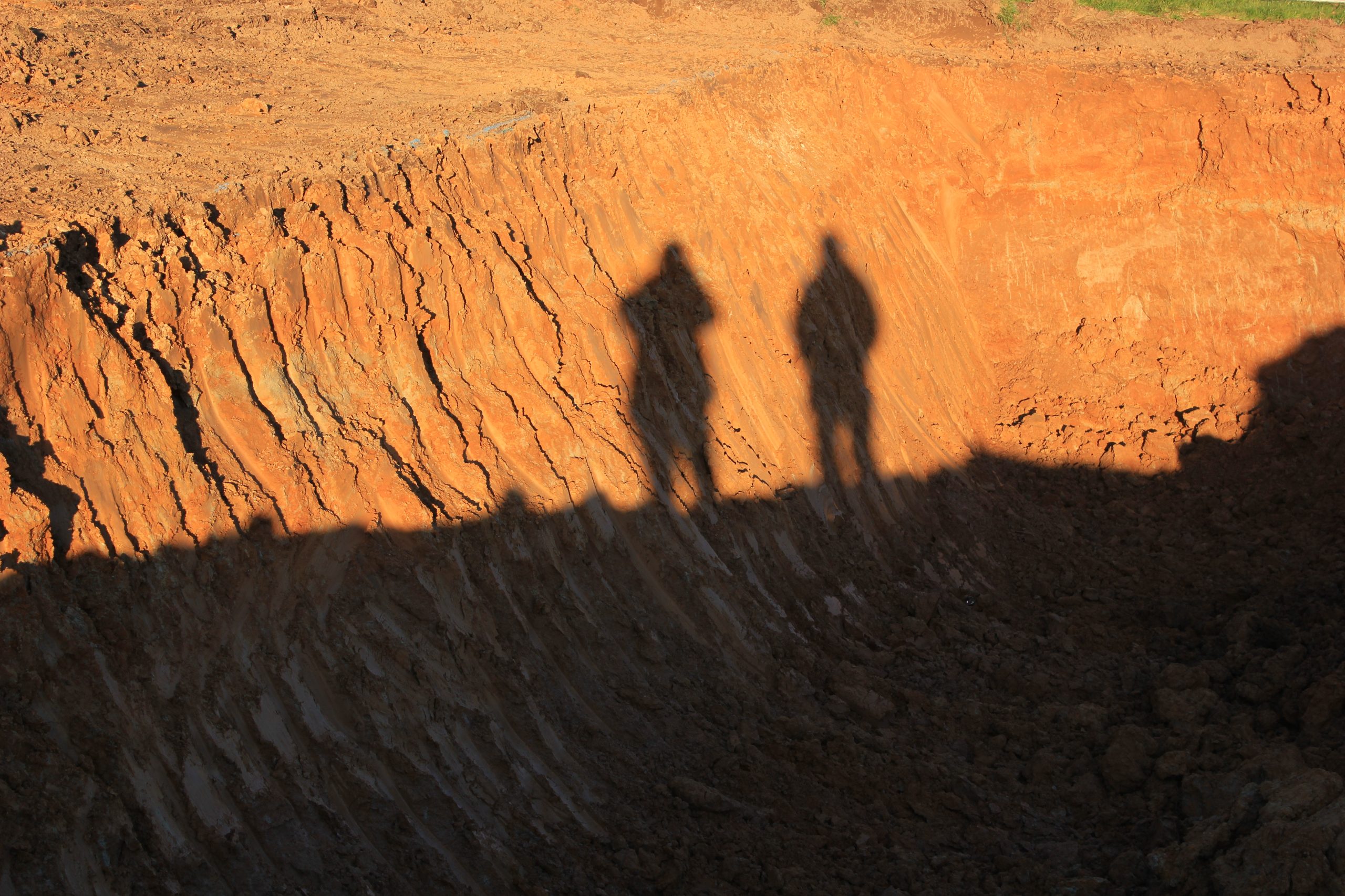 Shadows of two workers on a construction site