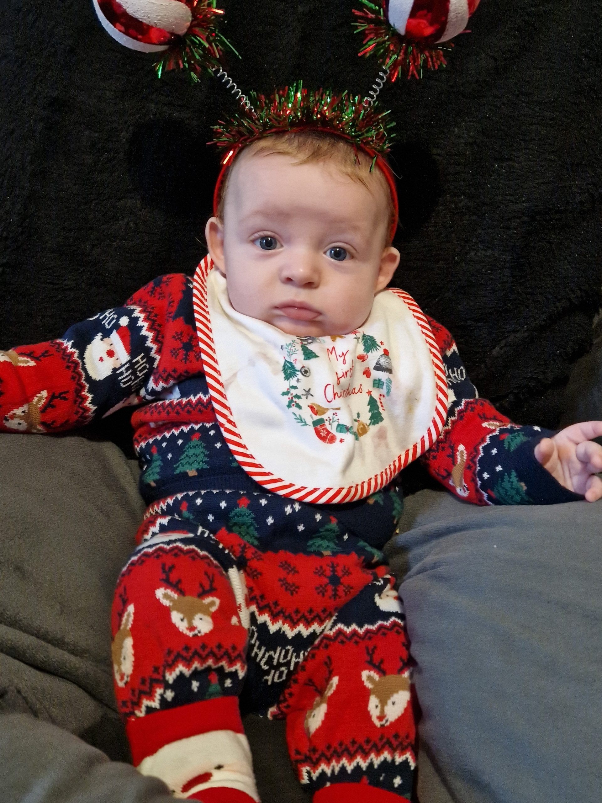 A baby wearing a christmas outfit