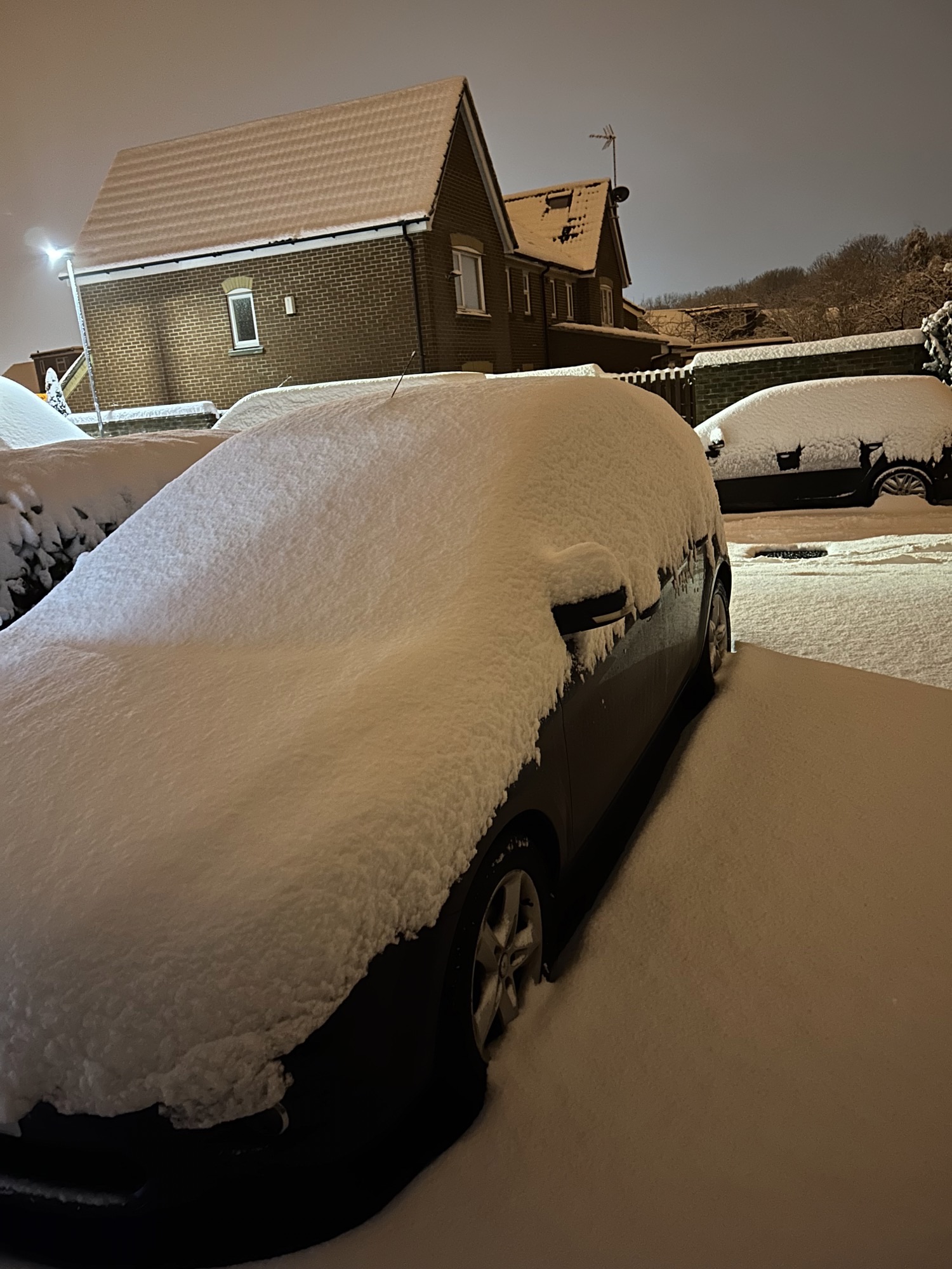 Cars covered in snow from a wintery blast