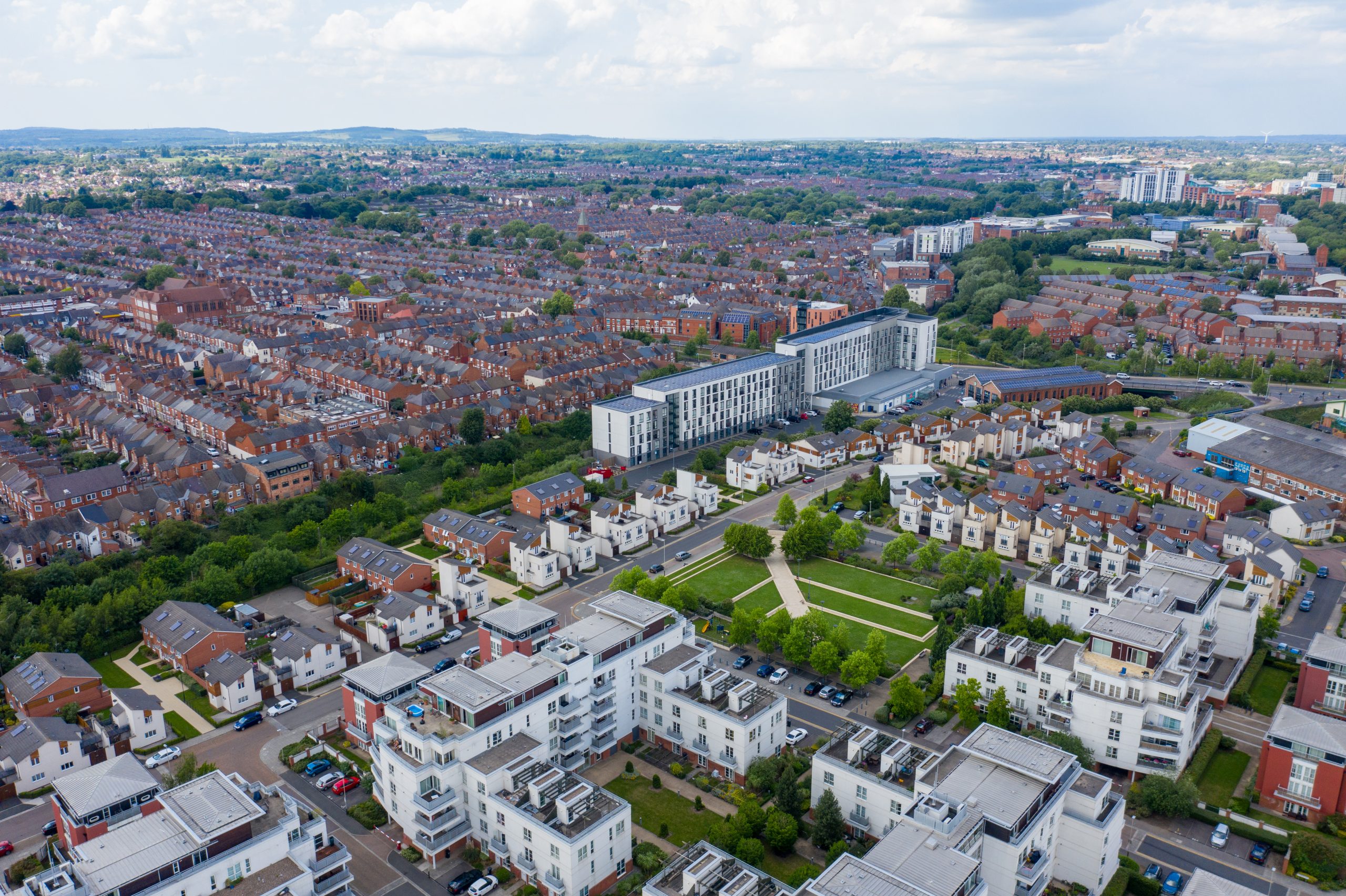 Aerial photo of the city centre of Leicester in the UK showing houses and apartment building on a sunny summers day with white clouds in the sky