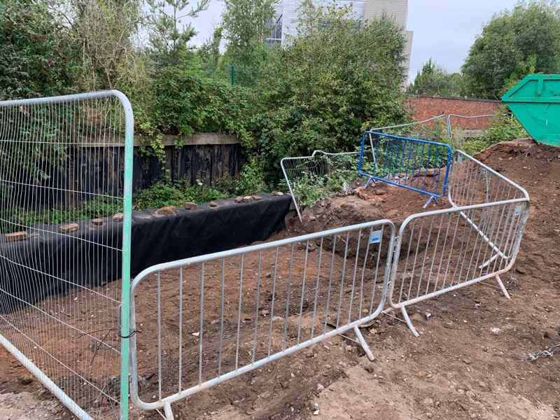 Rail fencing barrier blocking off excavation area